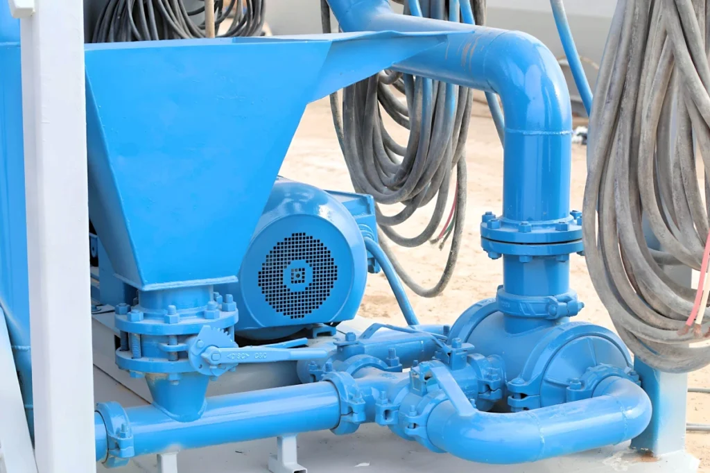 Blue industrial pump, pipes and hoses