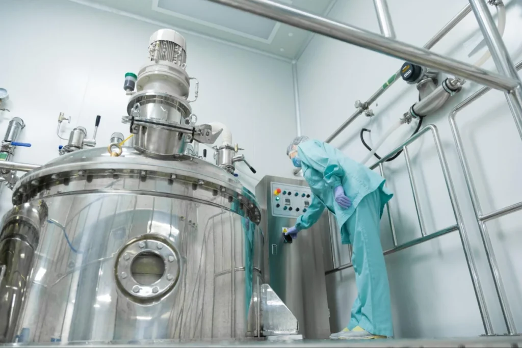Large steel tank and worker in sterile facility